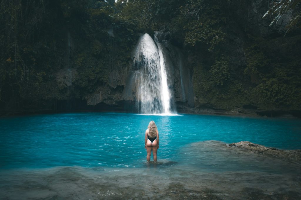 woman in blue bikini swimming on water